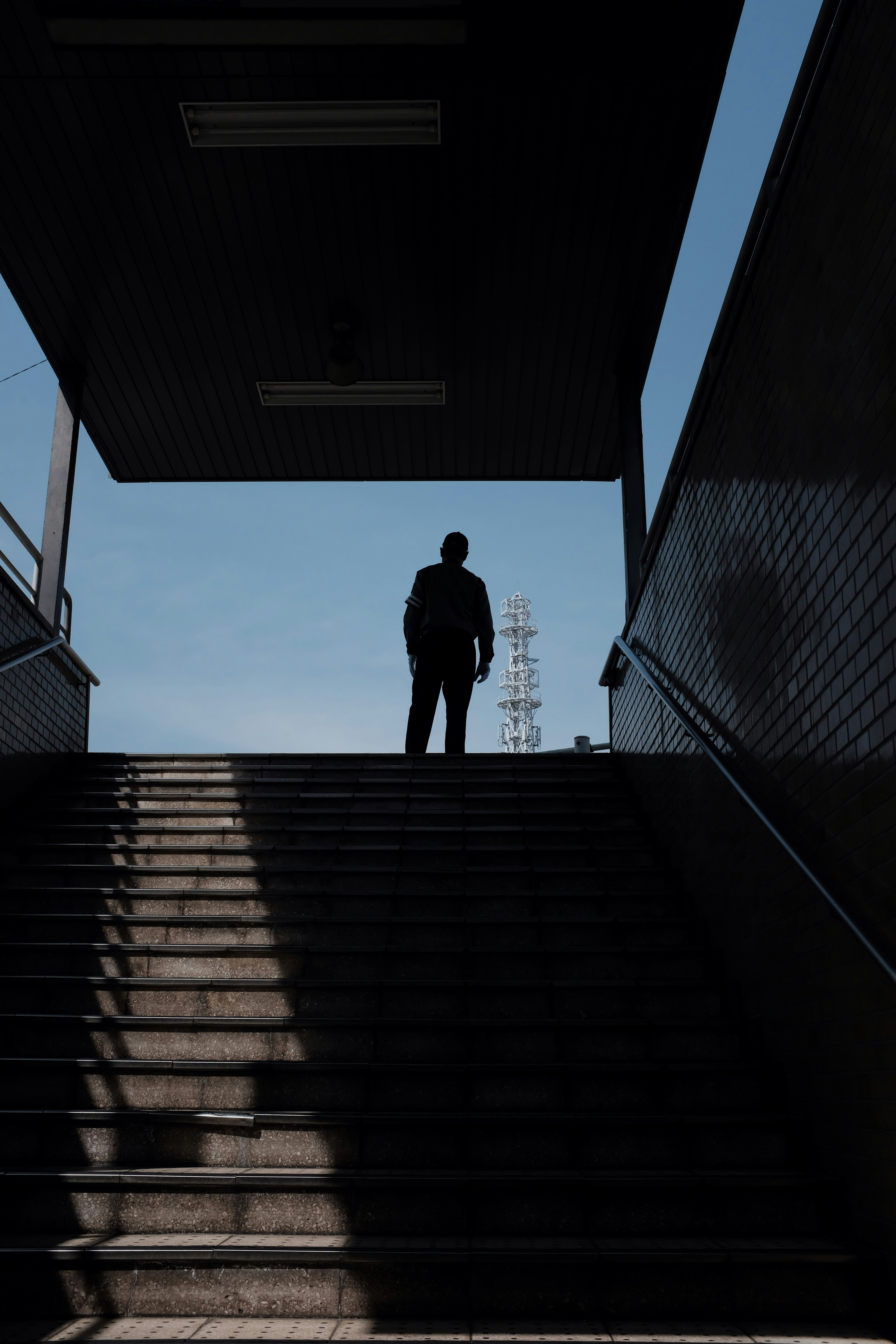 silhouette of man standing on stair